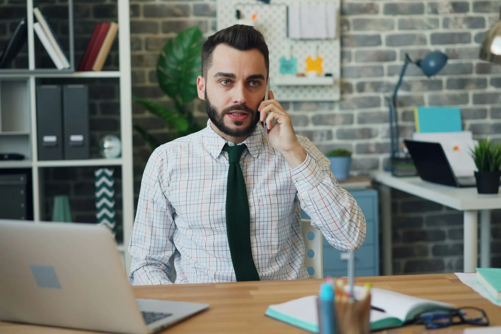 A business owner on the phone at his desk