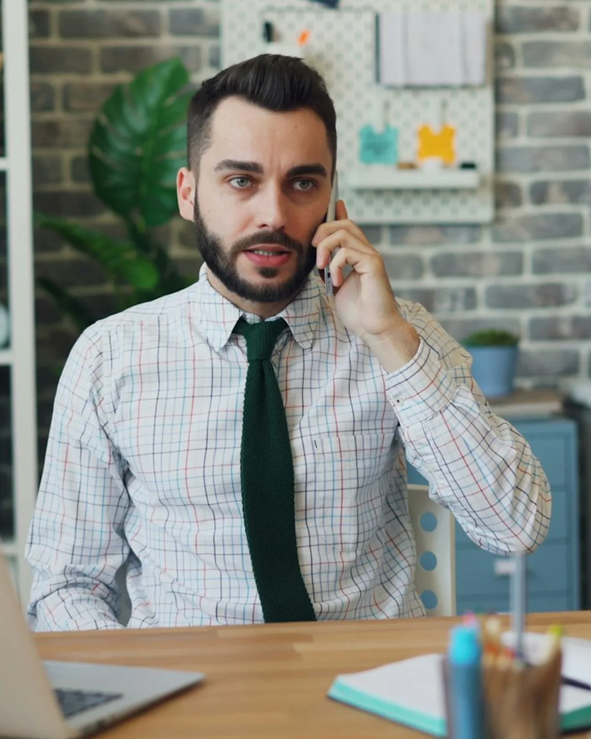 A business owner on the phone at his desk