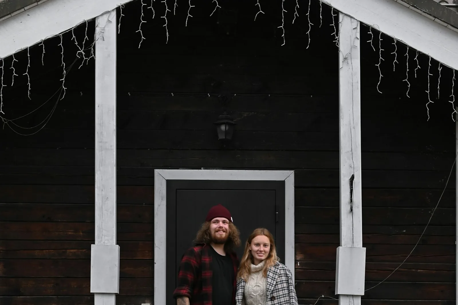 Homeowners in the doorway of their house