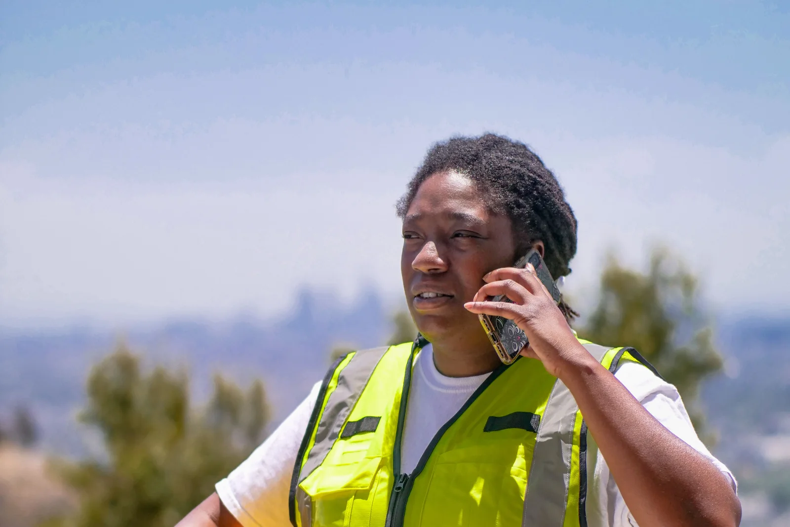 A construction worker answering a phone call on site