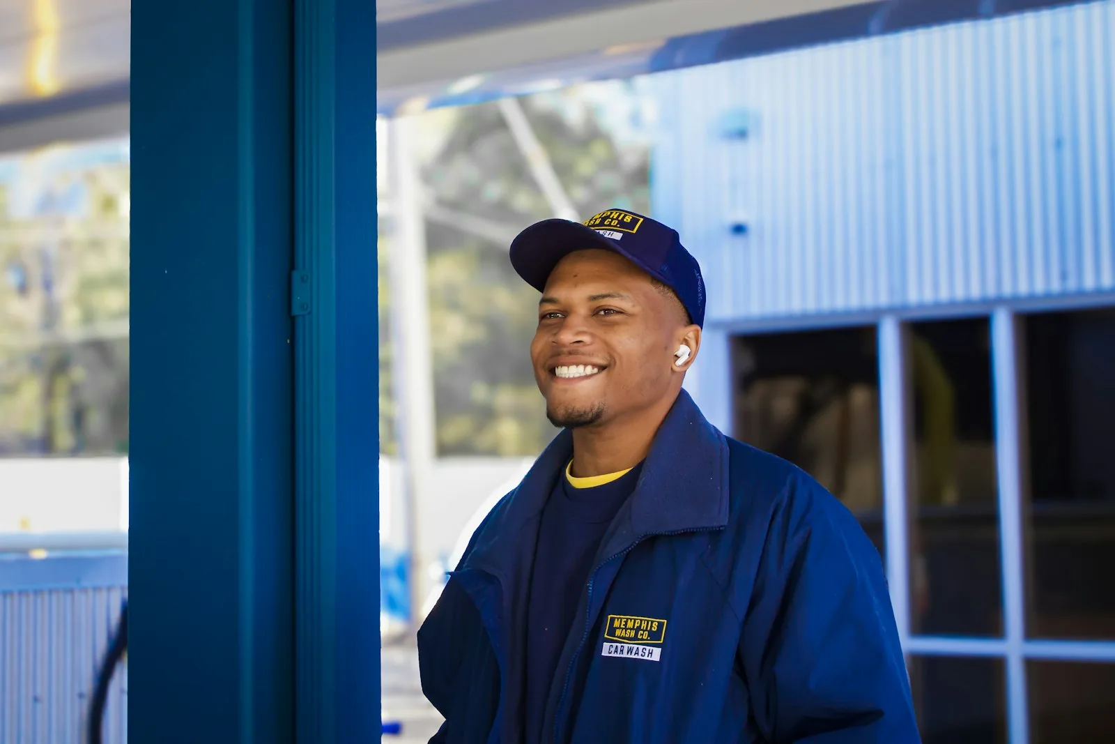 A uniformed service technician outside a shop